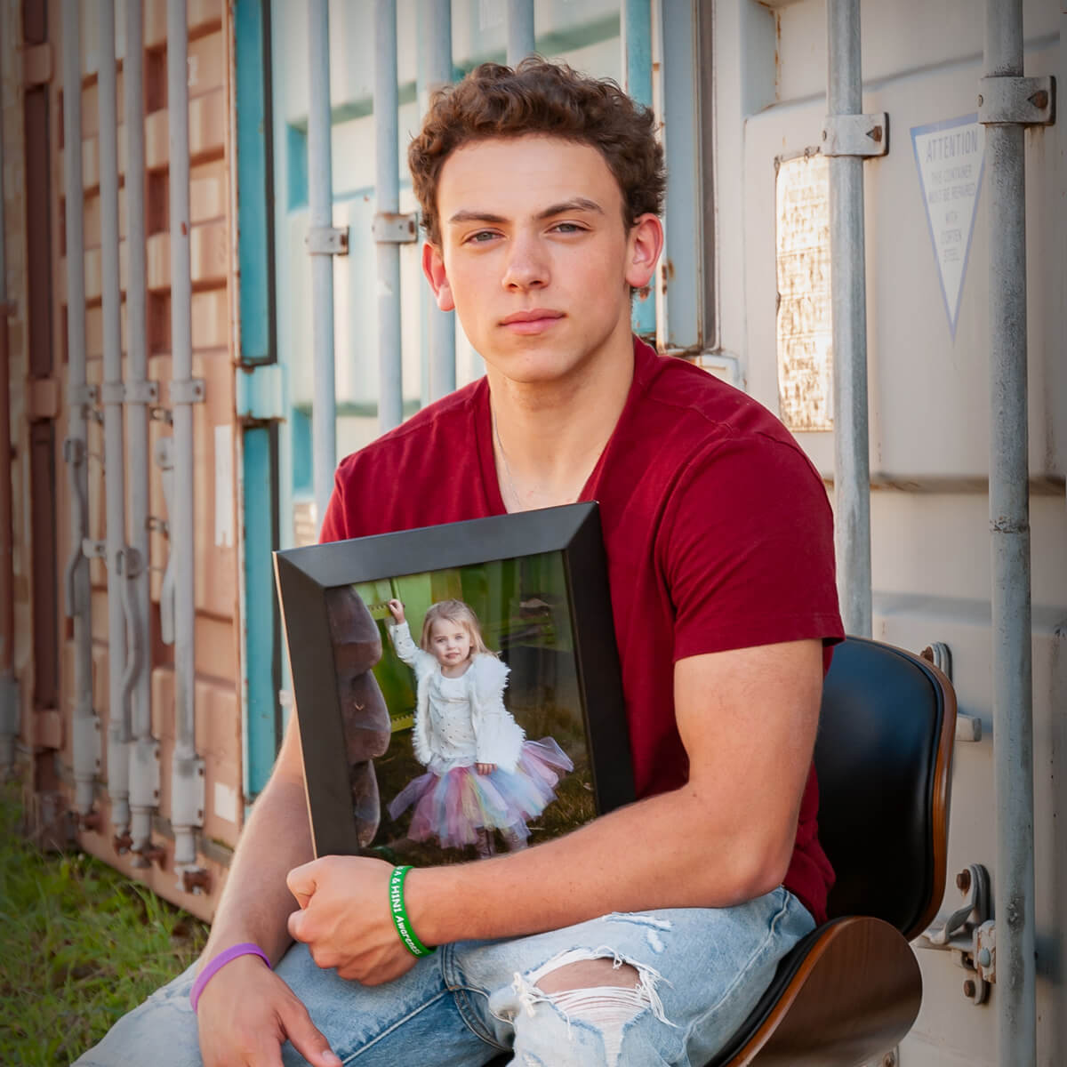Ethan Wehrkamp holding a photo of his sister, Gianna, who lost her life to the flu.